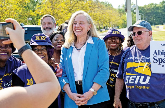 Democratic candidate for governor of Virginia Abigail Spanberger poses with government union supporters at a polling station in Fairfax, Virginia, Sept. 19, 2025. (Graeme Sloan/Bloomberg/Getty)