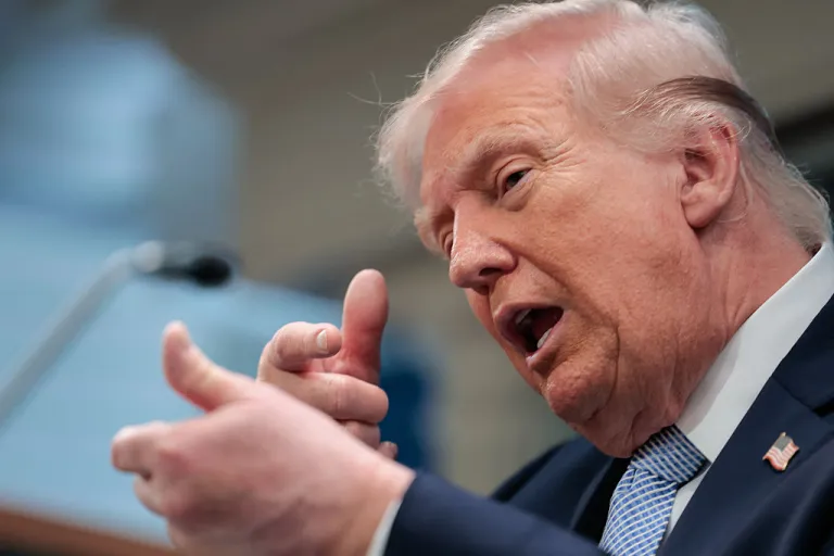 US President Donald Trump mimics firing a gun as he speaks about the conflict in Iran in the James S. Brady Press Briefing Room of the White House on April 6, 2026, in Washington, DC. (Photo by Kent Nishimura / AFP via Getty Images)