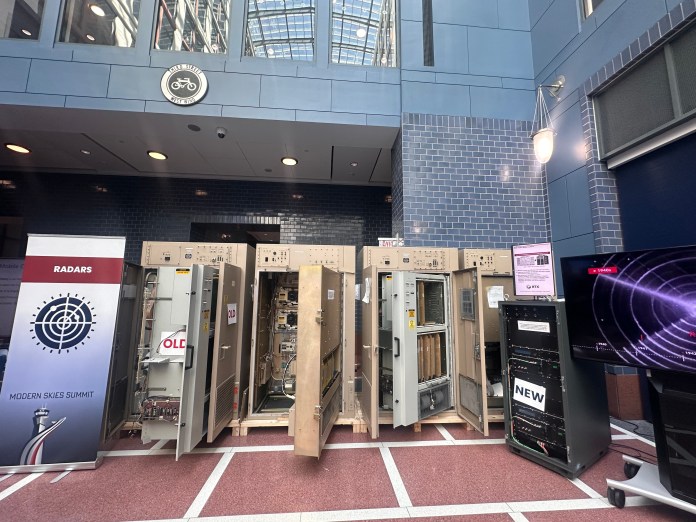 Decades-old radar cabinets are displayed next to newer digital systems at a Department of Transportation exhibit, illustrating the transition from aging air traffic control technology to modern replacements. (Samantha-Jo Roth, Washington Examiner)