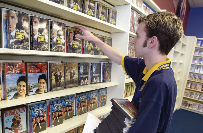 Blockbuster employee Mat Wangrow arranges DVD's on a shelf inside a Blockbuster Video store January 6, 2003 in Park Ridge, Illinois. (Tim Boyle/Getty Images)
