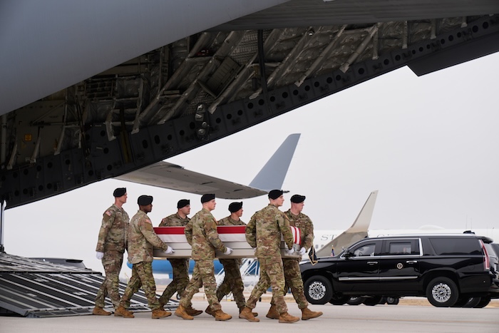 An Army carry team moves a flag-draped transfer case with the remains of U.S. Army Reserve soldier Maj. Jeffrey O'Brien.