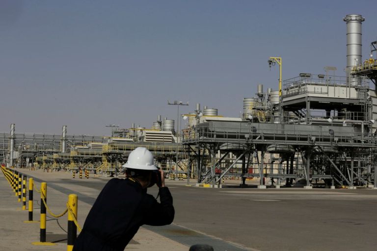 A photographer takes pictures of the Khurais oil field during a tour for journalists.